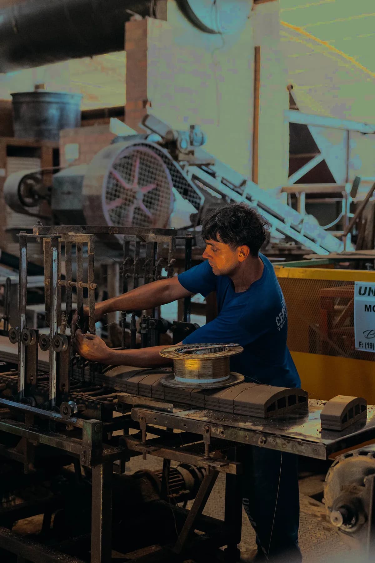 Industrial worker at a machine in a mid-sized business